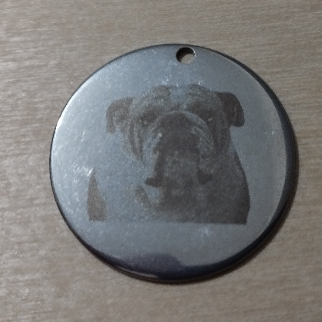 Close-up of custom engraved stainless steel pet tag — Photonscribe
